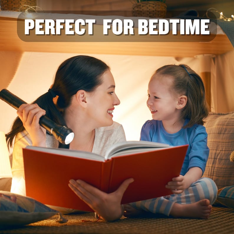 May include: A woman and a young girl are reading a book together in a tent. The woman is holding a flashlight and the girl is smiling. The text "PERFECT FOR BEDTIME" is visible above the tent.