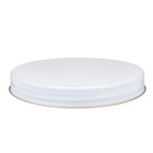 May include: White metal lid for a jar or container. The lid has a smooth, flat top and a slightly raised, textured rim.