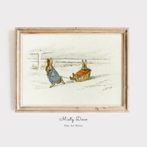 May include: A watercolor illustration of two brown rabbits in a snowy landscape. One rabbit is pulling a sled with the other rabbit sitting inside. The illustration is framed in a light wood frame.