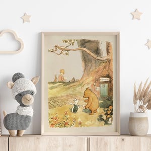 May include: A vintage illustration of Winnie the Pooh and Piglet standing in front of a tree house with the words "The Hundred Acre Wood" above the door. The illustration is in a light brown frame.