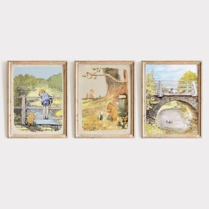May include: Three framed illustrations of scenes from Winnie the Pooh. The first shows Winnie the Pooh and Piglet walking in a forest. The second shows Christopher Robin looking at a river. The third shows Winnie the Pooh and Piglet walking across a bridge.