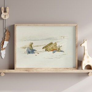 May include: A framed illustration of two rabbits in a snowy landscape. One rabbit is pulling a sled while the other rabbit is sitting in the sled. The sled is tipped over.
