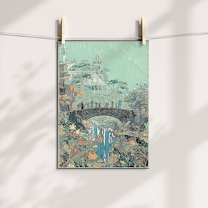 May include: A framed art print depicting a fantasy landscape with a bridge, waterfall, and buildings. The artwork features a color palette of greens, blues, and browns, with figures walking across the bridge. The print is held by wooden clips on a string.