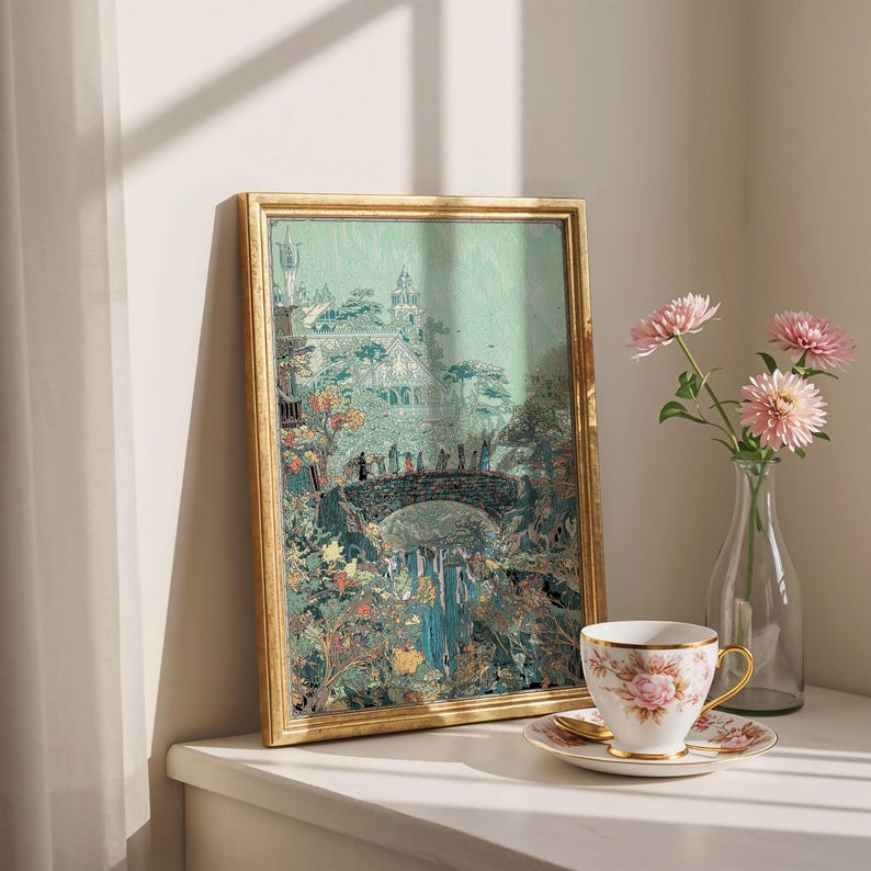 May include: A framed print with a gold-colored frame depicts a landscape with a bridge, waterfall, and buildings. A teacup and saucer with a floral design sit on a white surface, next to a vase with pink flowers.