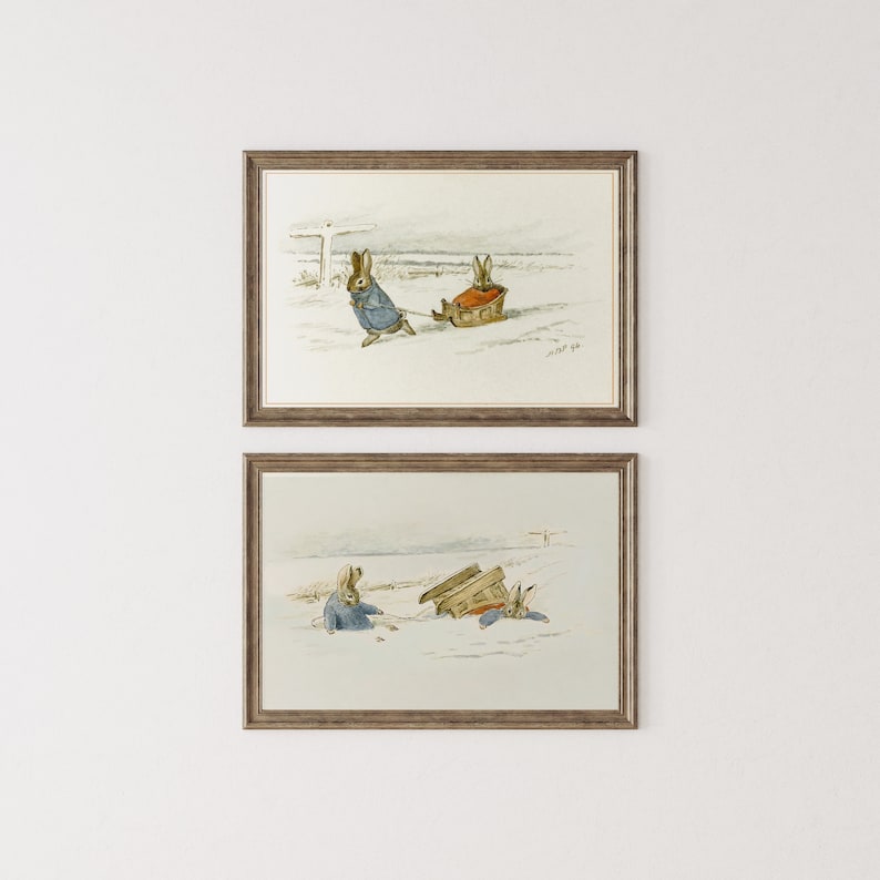 May include: Two framed illustrations of Peter Rabbit in the snow. In the top image, Peter Rabbit is pulling a sled with another rabbit on it. In the bottom image, Peter Rabbit is pulling a sled with another rabbit on it, but the sled has tipped over.