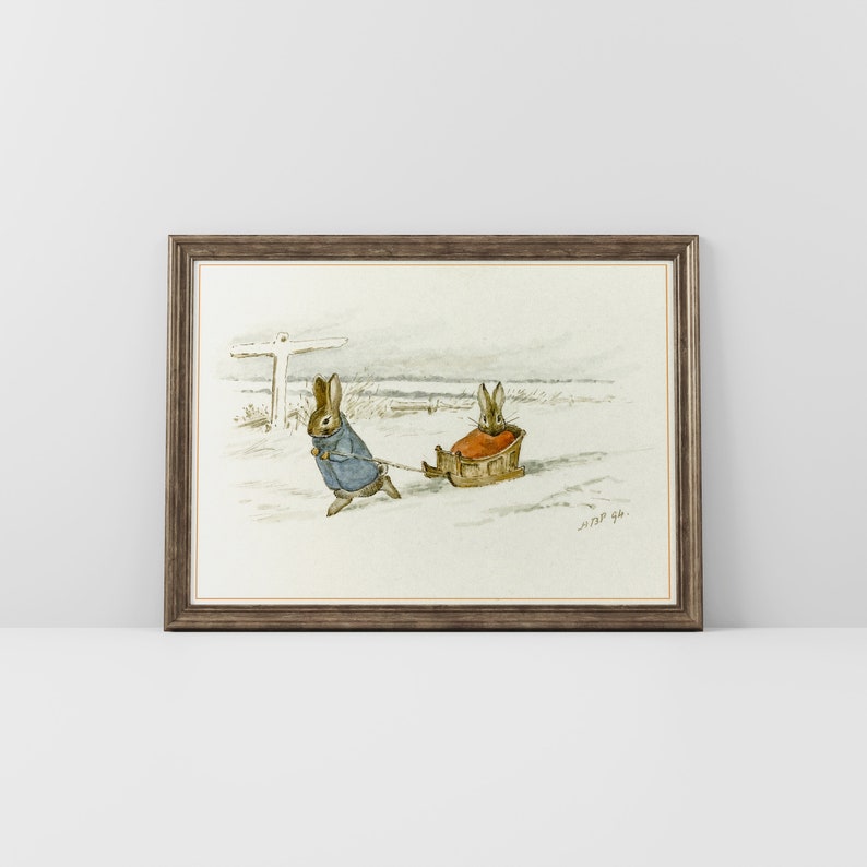 May include: A watercolor painting of two brown rabbits in a snowy landscape. One rabbit is pulling a sled with the other rabbit sitting in it. The painting is framed in a brown frame.