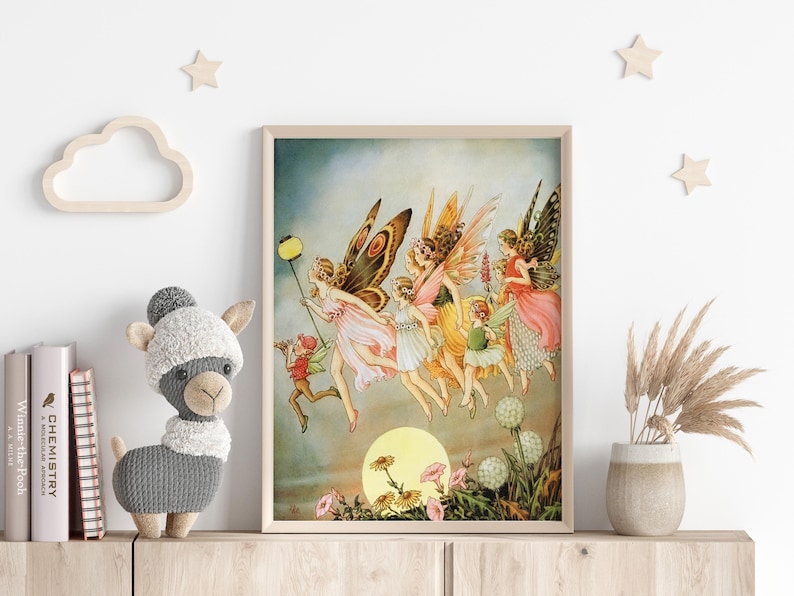 May include: A framed vintage print depicts a group of fairies with butterfly wings, flying towards a large yellow sun. The fairies wear colorful dresses and are holding a lantern. The artwork is displayed on a wooden shelf.