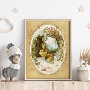 May include: A vintage illustration of a brown rabbit holding an umbrella and a basket, walking through a snowy forest. The illustration is framed in a gold oval with ornate details.