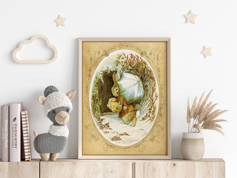 May include: A vintage illustration of a brown rabbit holding an umbrella and a basket, walking through a snowy forest. The illustration is framed in a gold oval with ornate details.
