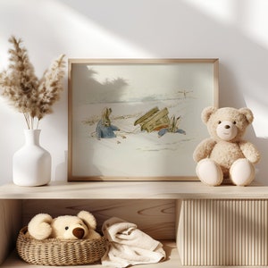 May include: A framed illustration of two rabbits in a snowy landscape. The rabbits are wearing blue clothing and are pulling a wooden sled. A brown teddy bear sits on a wooden shelf below the picture.