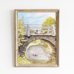 May include: A framed illustration of a stone bridge with a white wooden railing. Two small animals are sitting on the railing, looking at each other. The bridge is over a stream with green trees and a blue sky in the background.
