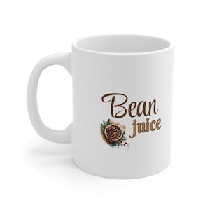 May include: White ceramic coffee mug with a brown graphic of coffee beans and the text "Bean juice".