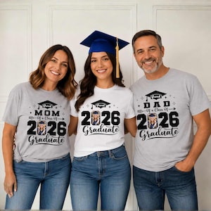 Three people wearing graduation t-shirts with the text "I'm proud of my class of 2026 Graduate" are posing together.