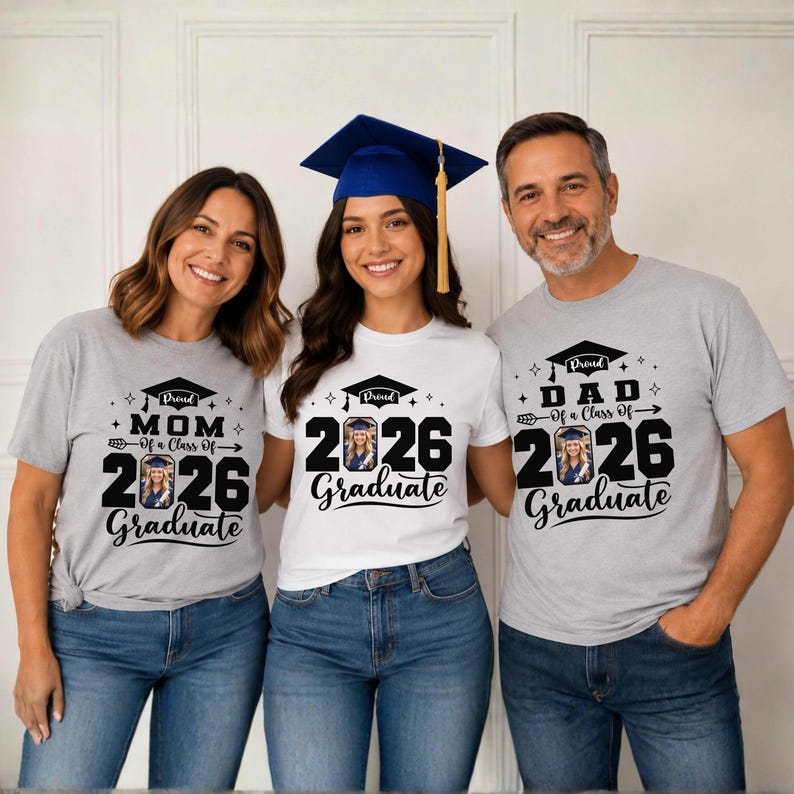 Three people wearing graduation t-shirts with the text "I'm proud of my class of 2026 Graduate" are posing together.