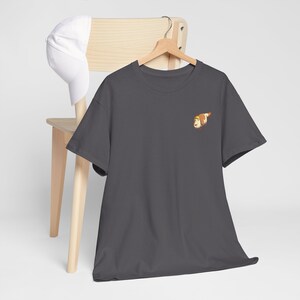 May include: A dark gray t-shirt with a small embroidered image of a cartoon dog on the left chest.