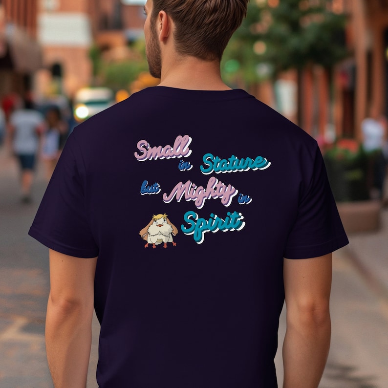 May include: A dark blue t-shirt with a cartoon bird and the text "Small in Stature but Mighty in Spirit" in pink and blue lettering.