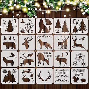 May include: Set of 20 reusable stencils featuring various woodland animal and nature designs. The stencils are white and made of a durable plastic material. The designs include a wolf, deer, bear, fox, moose, trees, mountains, snowflakes, and more.