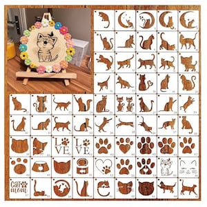 May include: A set of 65 stencils featuring various cat designs, including paw prints, hearts, and the words "Love" and "Cat Mom". The stencils are made of white plastic and are arranged in a grid pattern on a wooden background.