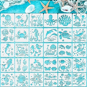 May include: A set of 16 white plastic stencils with various sea-themed designs. The stencils feature images of mermaids, seahorses, starfish, seashells, coral, and fish. The text on the stencils includes "Under the Sea", "I the Beach", and "The Beach is Calling".