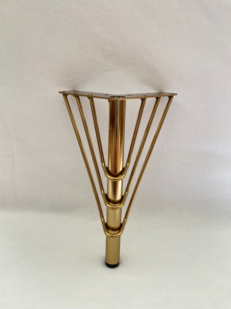 May include: Gold metal table leg with a triangular base and five support bars.