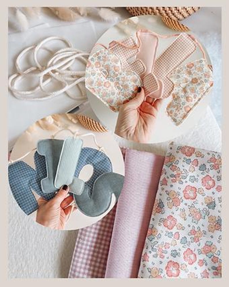 May include: A collection of handmade fabric decorations and materials. The image features a floral heart, gingham shapes, and the letters "MOM" in various pastel fabrics. Rolls of pink and floral fabric are also visible, along with a white rope.