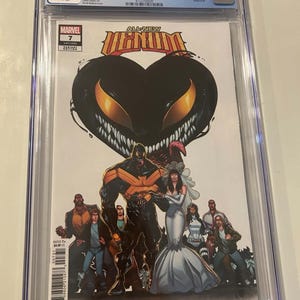 May include: A CGC graded 9.6 All-New Venom #7 comic book in a clear plastic slab. The cover features a large black heart-shaped creature with yellow eyes above a black-suited character and a person in a white wedding dress surrounded by others.