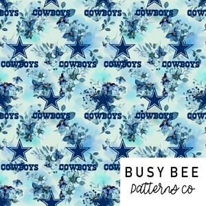 May include: A seamless pattern featuring a blue watercolor floral design with a white background. The pattern includes blue five-pointed stars and the word "COWBOYS" repeated throughout. The text "BUSY BEE patterns co" is in the bottom right corner.