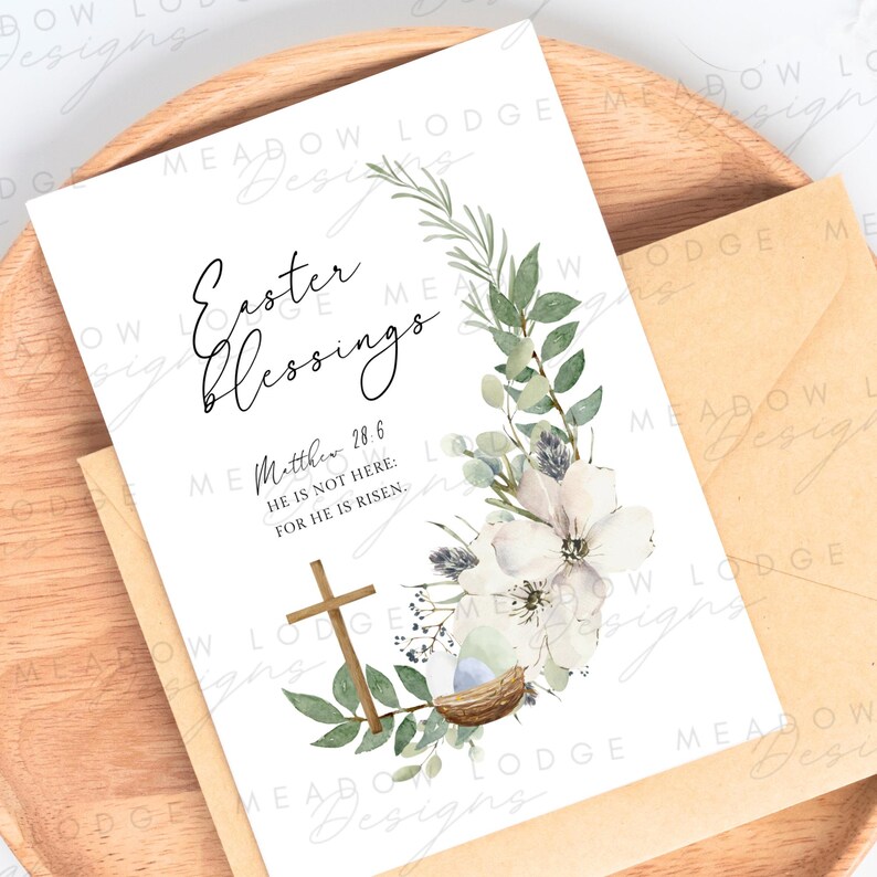 May include: A white card with a watercolor floral wreath and a cross. The card has the text "Easter Blessings" and a Bible verse: "Matthew 28:6 He is not here: for he is risen."