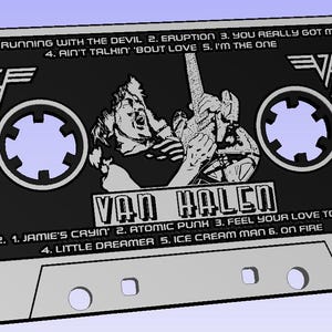 May include: A black cassette tape with a silver case. The tape features a black and white image of a rock band member playing a guitar. The text "VAN HALEN" is printed in white on the tape. The tape lists the song titles "RUNNING WITH THE DEVIL", "ERUPTION", "YOU REALLY GOT ME", "AIN'T TALKIN' 'BOUT LOVE", "I'M THE ONE", "JAMIE'S CAYIN'", "ATOMIC PUNH", "FEEL YOUR LOVE TONIGHT", "LITTLE DREAMER", "ICE CREAM MAN", and "ON FIRE".