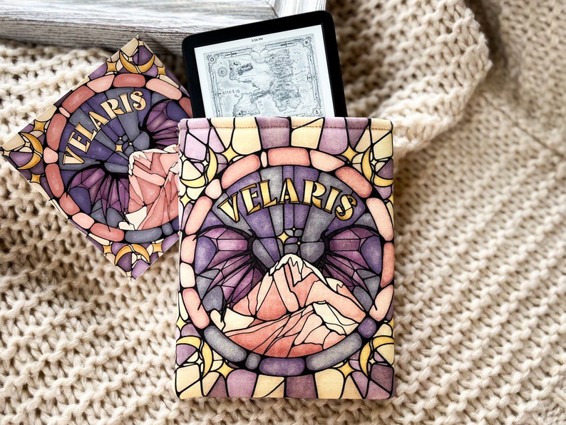 May include: A stained glass style e-reader cover with a purple, pink, and yellow design. The cover features a mountain range and the word "VELARIS" in gold lettering.