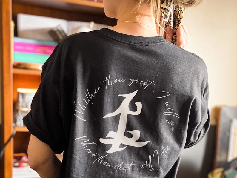 May include: Black t-shirt with a white graphic design featuring a stylized symbol and the text "Whither thou goest, I will go. Where thou diest, will I die."