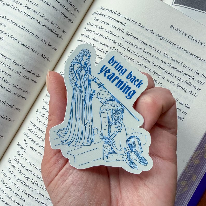 May include: A blue and white sticker featuring a medieval-style illustration of a kneeling figure and a woman holding a sword. The sticker has the text "bring back yearning" in a blue, uppercase font.