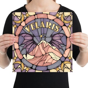 K&ouml;nnte beinhalten: Eine Illustration im Stil eines Buntglasfensters mit einer Bergkette mit Fl&uuml;geln und dem Wort "VELARIS" in goldenen Buchstaben. Der Hintergrund ist ein purpurnes, rosa und gelbes Mosaik.