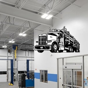 May include: A black and white illustration of a semi-truck with a trailer hauling logs. The truck is on a white wall in a garage setting.