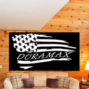 May include: A black and white distressed American flag with the word "DURAMAX" written in white across the middle of the flag.