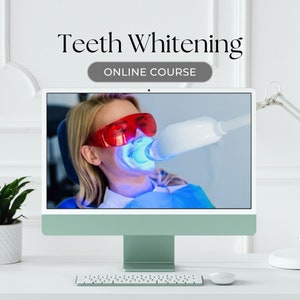 May include: A computer screen showing a woman having a teeth whitening treatment. The screen is on a white desk with a white lamp and a potted plant. The text "Teeth Whitening" and "Online Course" is displayed on the screen.