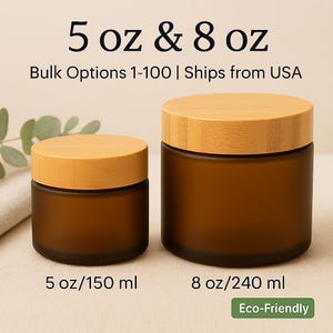 May include: Two brown glass jars with wooden lids. The jars are labeled 5 oz and 8 oz. The text "Bulk Options 1-100" is above the jars. The smaller jar is labeled 5 oz/150 ml, and the larger jar is labeled 8 oz/240 ml. The jars are eco-friendly.