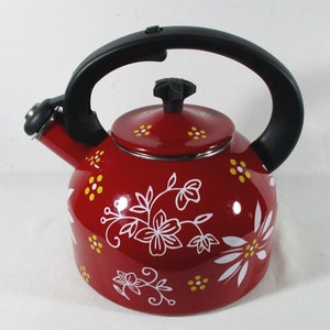 May include: Red enamel teapot with a black handle and a floral design in white and yellow.