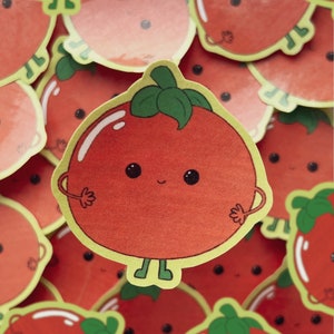 Peut inclure: Un autocollant de tomate rouge en dessin animé avec une tige et des feuilles vertes. La tomate a un visage souriant avec de grands yeux et une petite bouche. L'autocollant a un contour jaune.