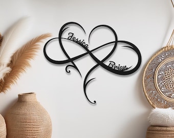 May include: Black metal wall art featuring an infinity symbol intertwined with a heart shape. The names "Jessica" and "Brian" are written inside the design.