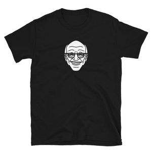 May include: Black t-shirt with a white outline of a man wearing glasses and smiling.