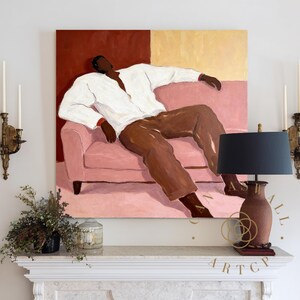 May include: A large square painting depicts a person reclining on a pink sofa. The person wears a white shirt and brown pants. The background is divided into red and gold sections. A black lamp and decorative items sit on a white mantel.