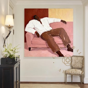 May include: An abstract painting depicts a person reclining on a pink sofa. The figure wears a white shirt and brown pants. The background features a red and yellow color block design. A decorative chair and a black cabinet are in the foreground.