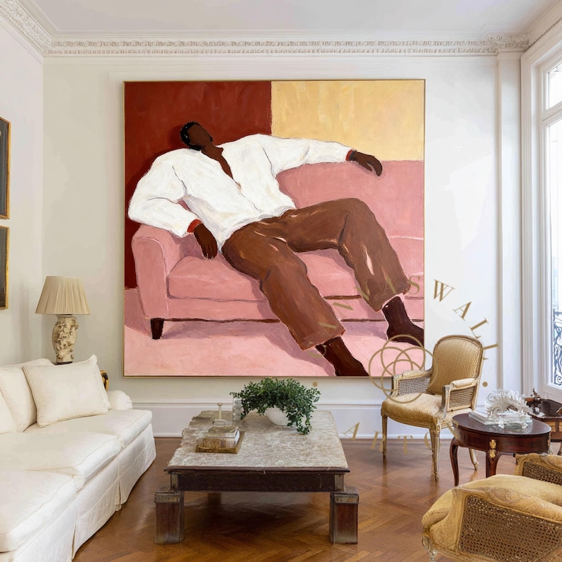 May include: Large abstract painting depicting a figure reclining on a pink sofa. The figure wears a white shirt and brown pants against a red and yellow backdrop. The artwork is displayed in a well-lit living room with a white sofa and wooden floors.