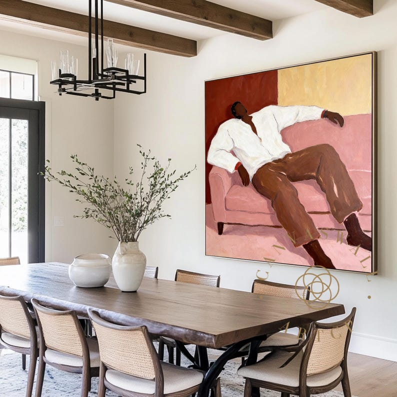 May include: A dining room featuring a large wooden table with eight chairs. A large abstract painting hangs on the wall, depicting a person in a white shirt and brown pants. A black chandelier hangs above the table, and a vase of greenery sits on the table.