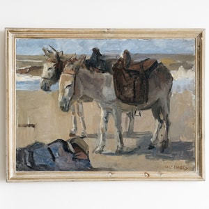 Puede incluir: Una pintura al óleo enmarcada que representa dos burros con sillas de montar en una playa. Los burros están mirando al espectador, y la pintura está firmada "Max Frankel" en la esquina inferior derecha.