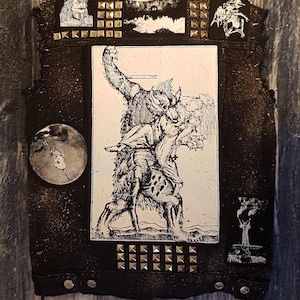 May include: Black leather vest with silver studs and patches. The patches feature a black and white illustration of a werewolf, a moon, and a tree.