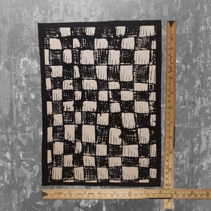 May include: Black and white checkered fabric patch with a rough, hand-drawn texture. The patch is approximately 8 inches by 10 inches.