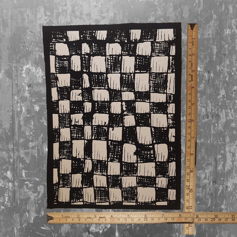 May include: Black and white checkered fabric patch with a rough, hand-drawn texture. The patch is approximately 8 inches by 10 inches.