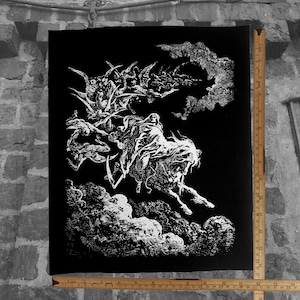 May include: Black and white illustration of a figure on horseback, surrounded by other figures and clouds. The artwork is a detailed, gothic-style drawing. The image is printed on a black canvas. A ruler is placed next to the canvas, measuring up to 36 inches.